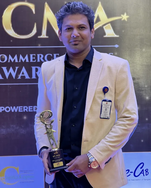 Tawfique Ahmed holding an e-commerce award