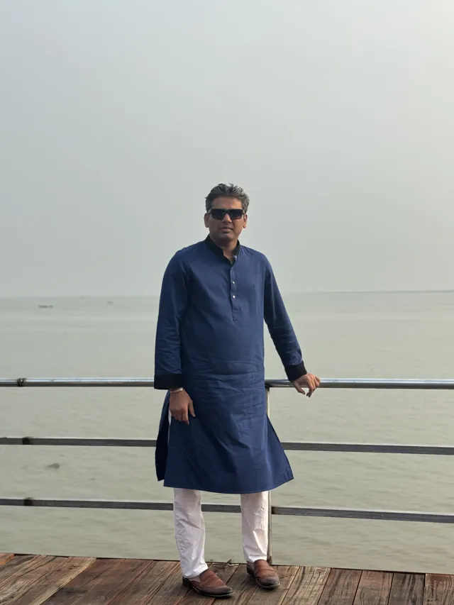 Tawfique Ahmed beside a broad stretch of water